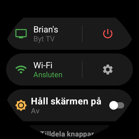 Klockans meny med den aktiva TV:n överst och genvägen Byt TV bredvid en röd på/av-knapp